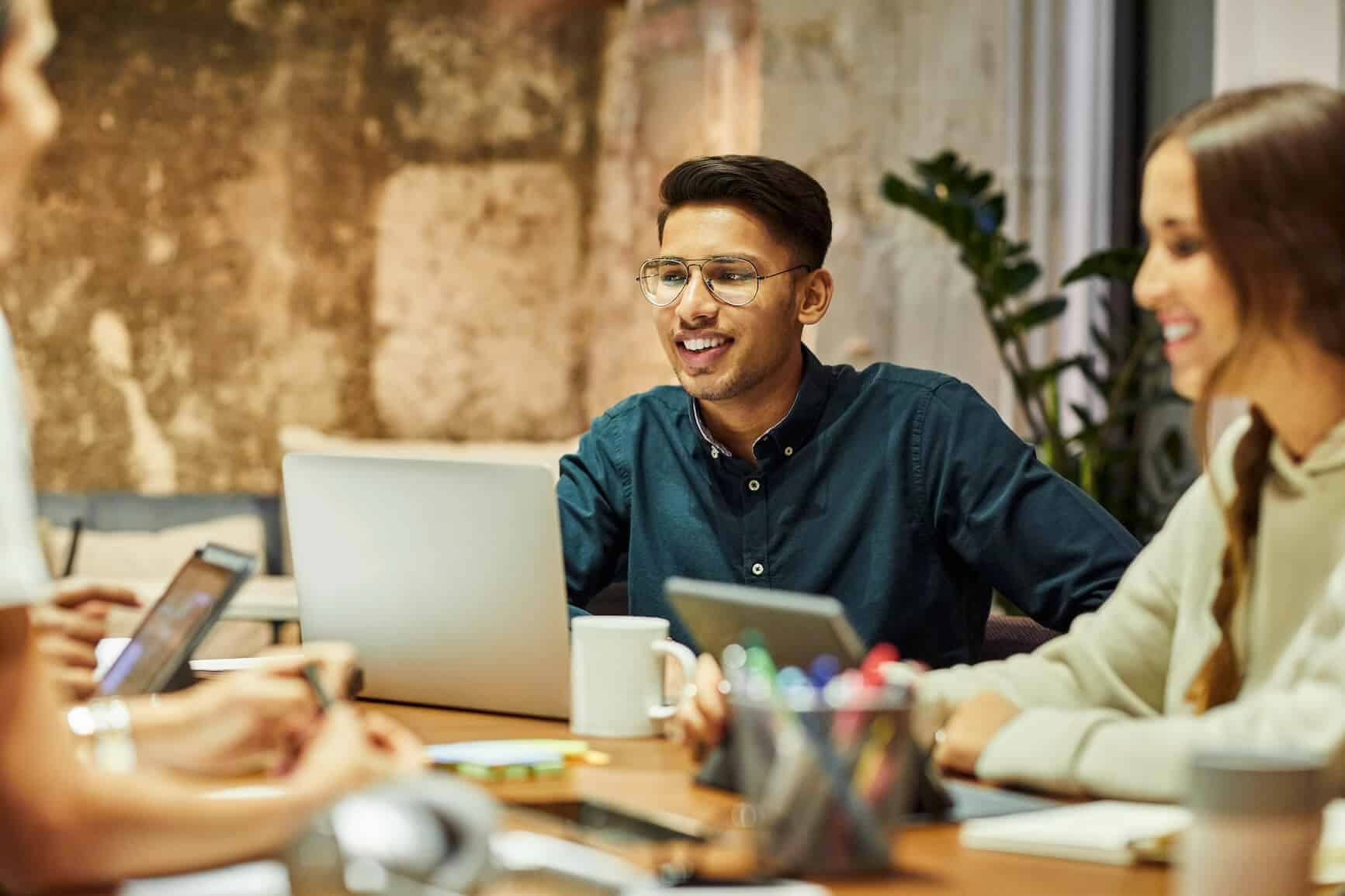 Two colleagues smile while working