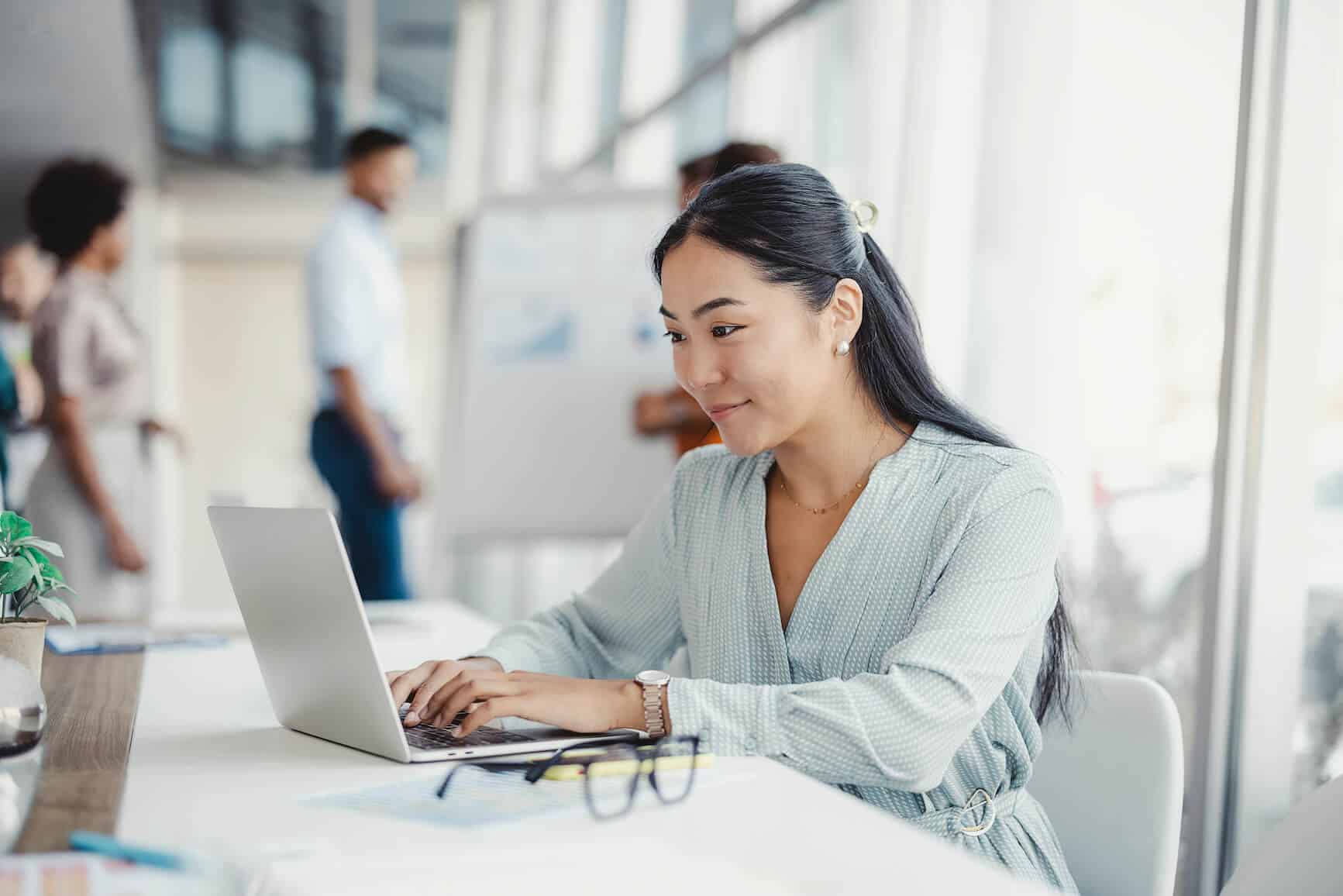 businesswoman types laptop office