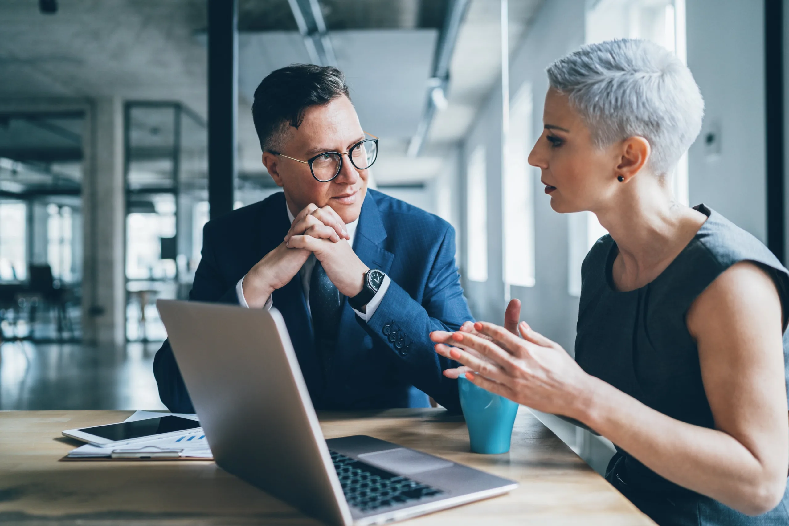 business executives speak at desk