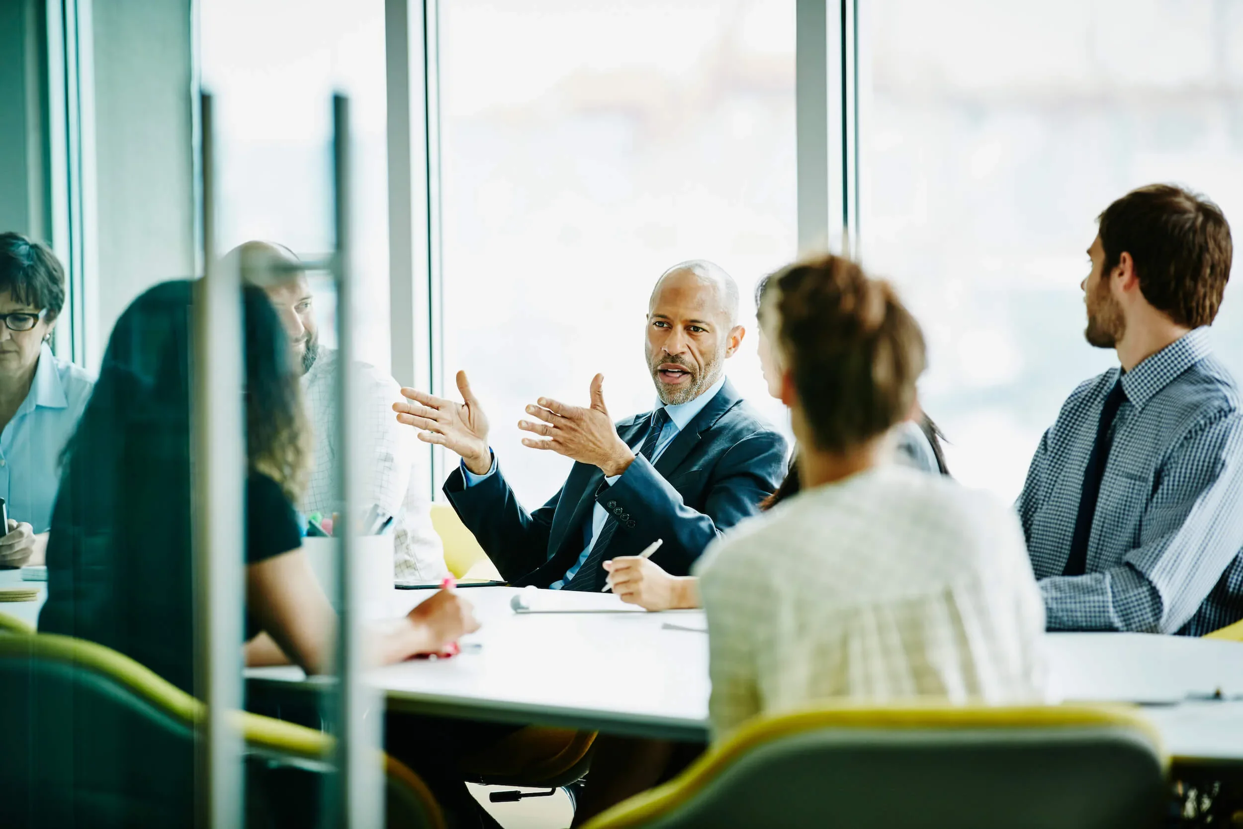 business leader conducts meeting in office