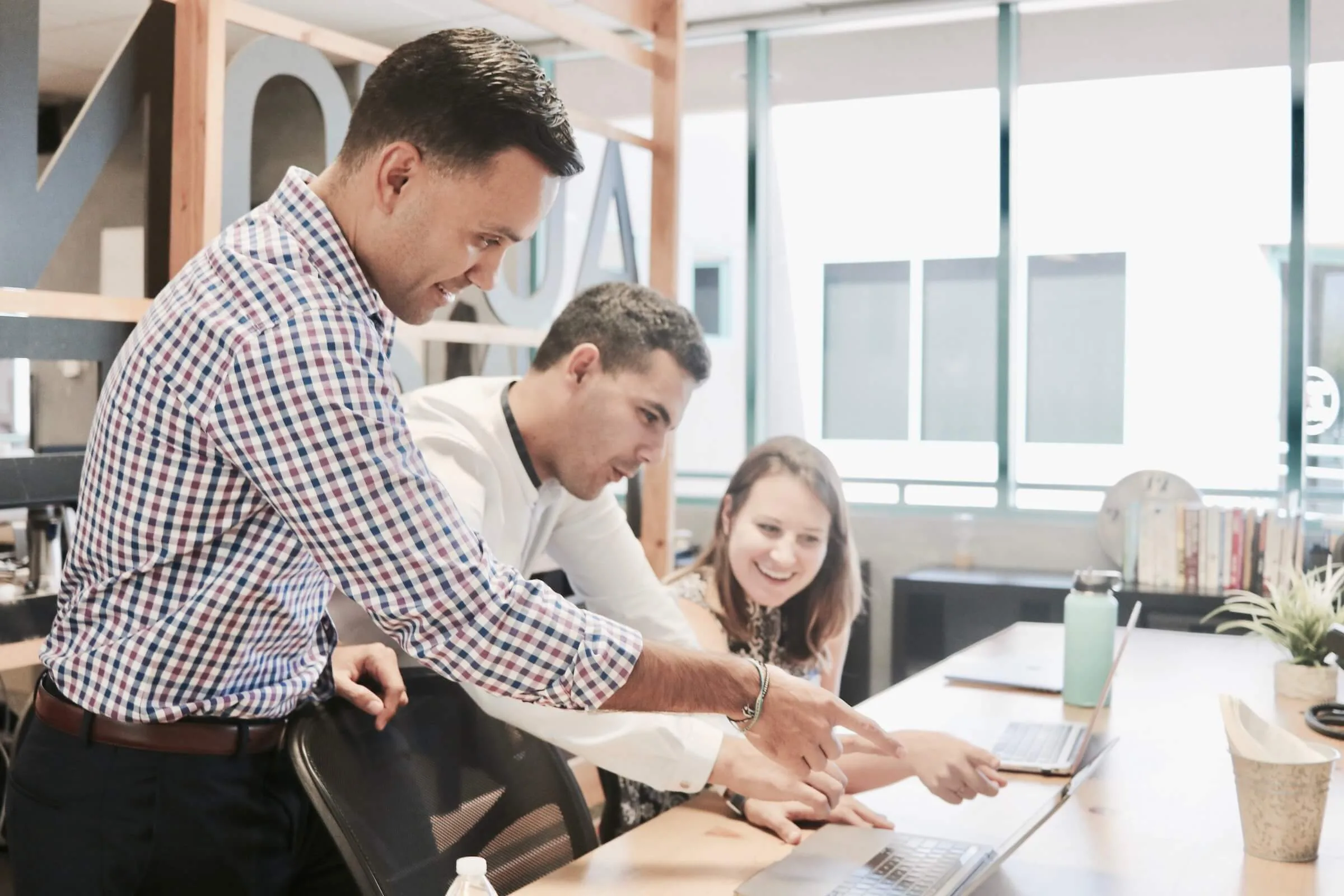 business team gathers around desk