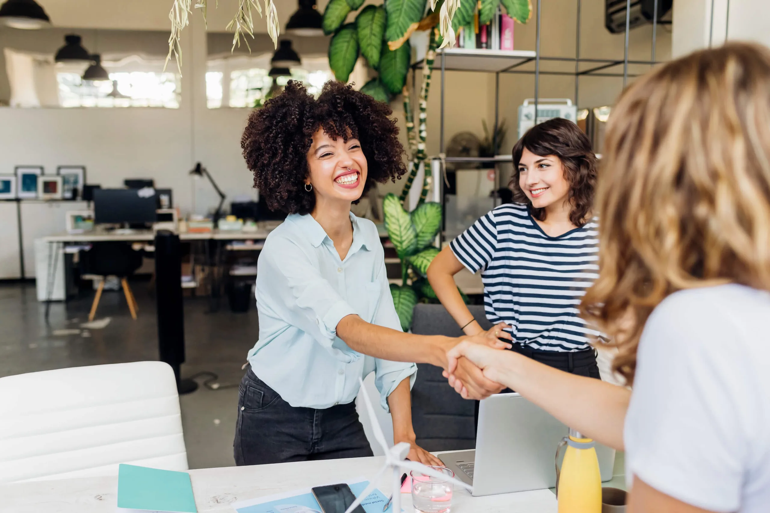 hiring manager shakes job candidate hand