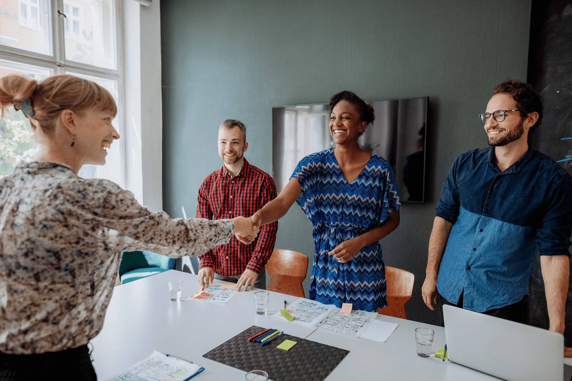 hiring team shakes hands job candidate