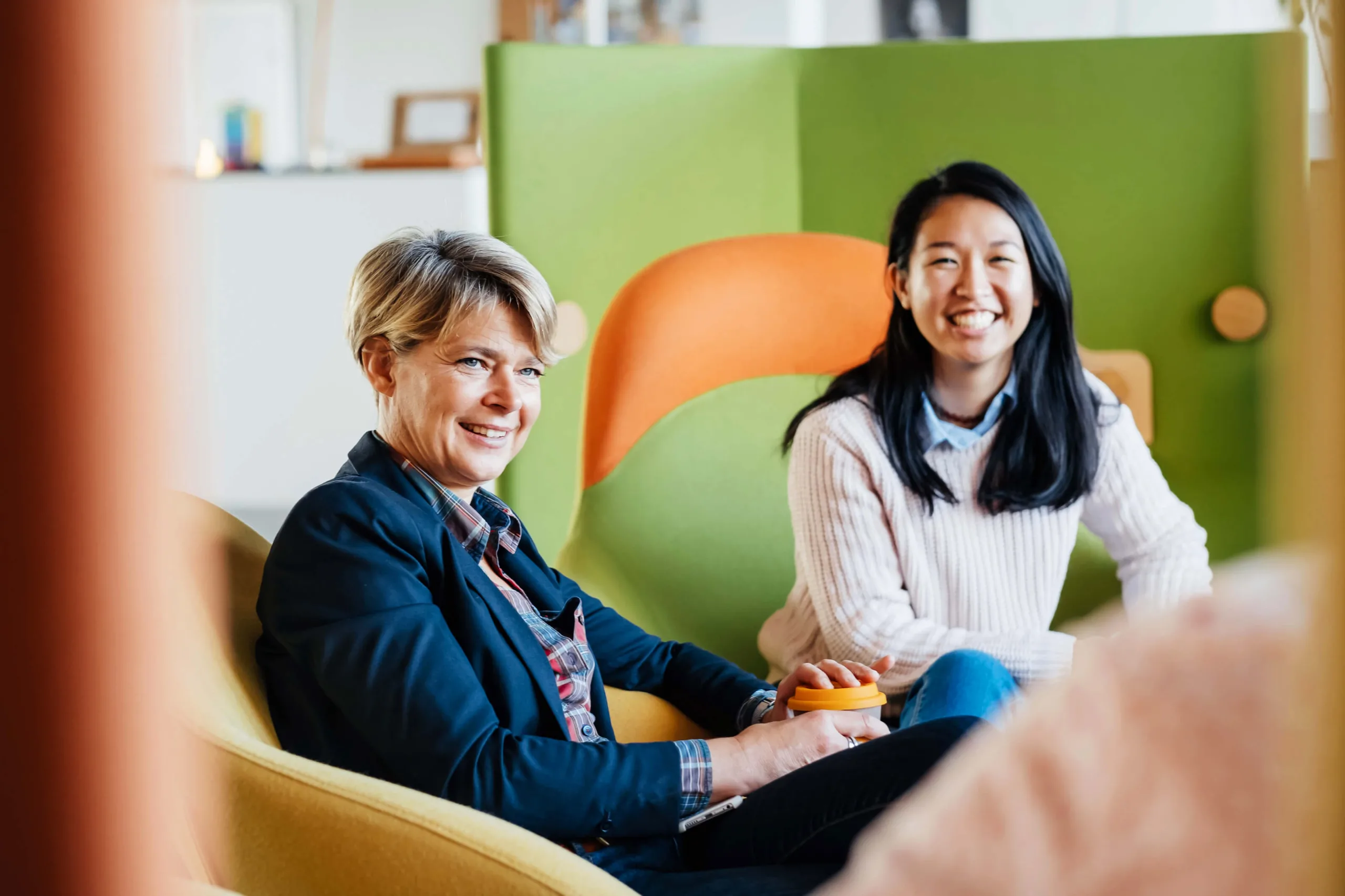 smiling colleagues in office chairs