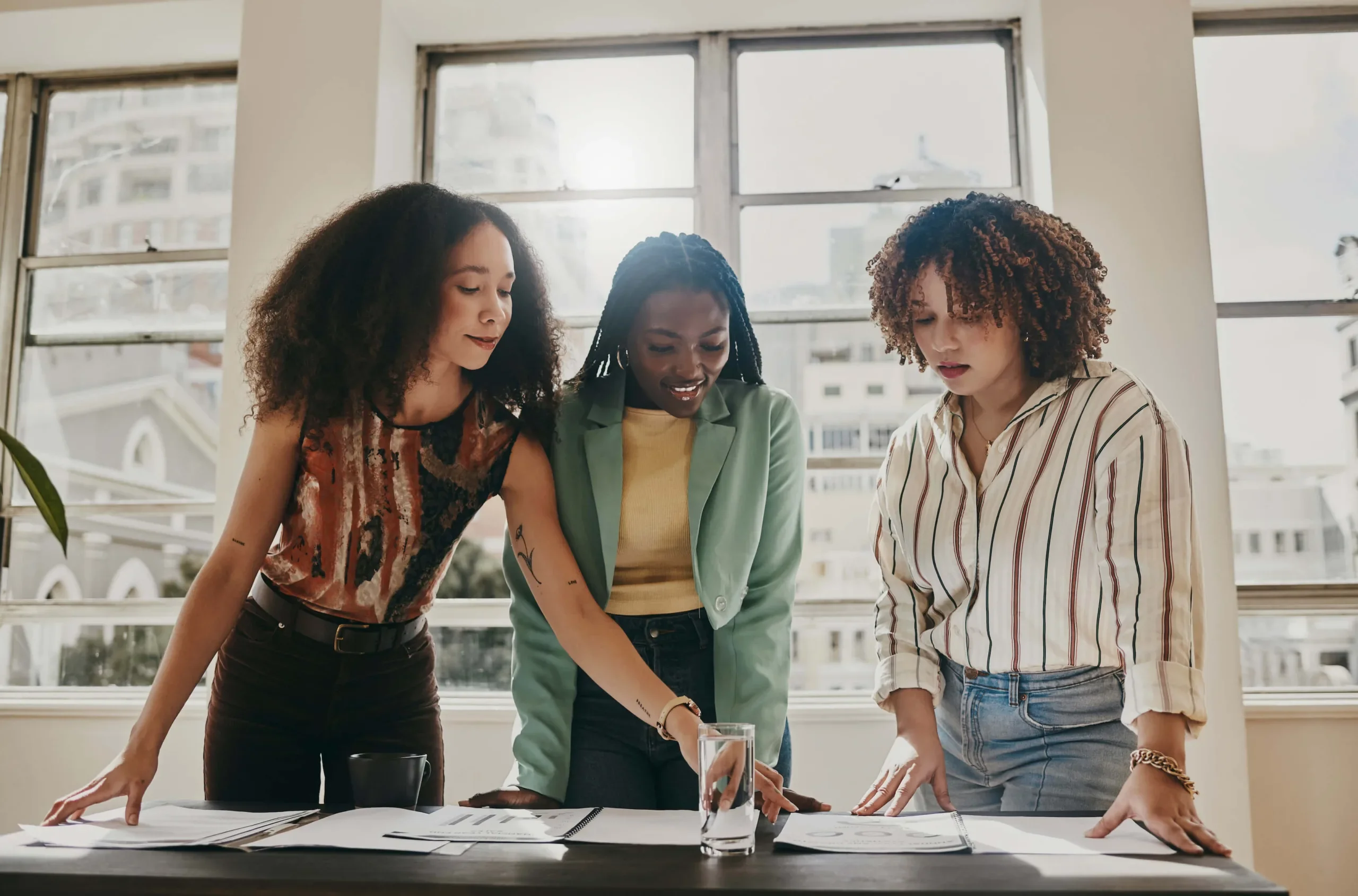 three young business professionals over desk