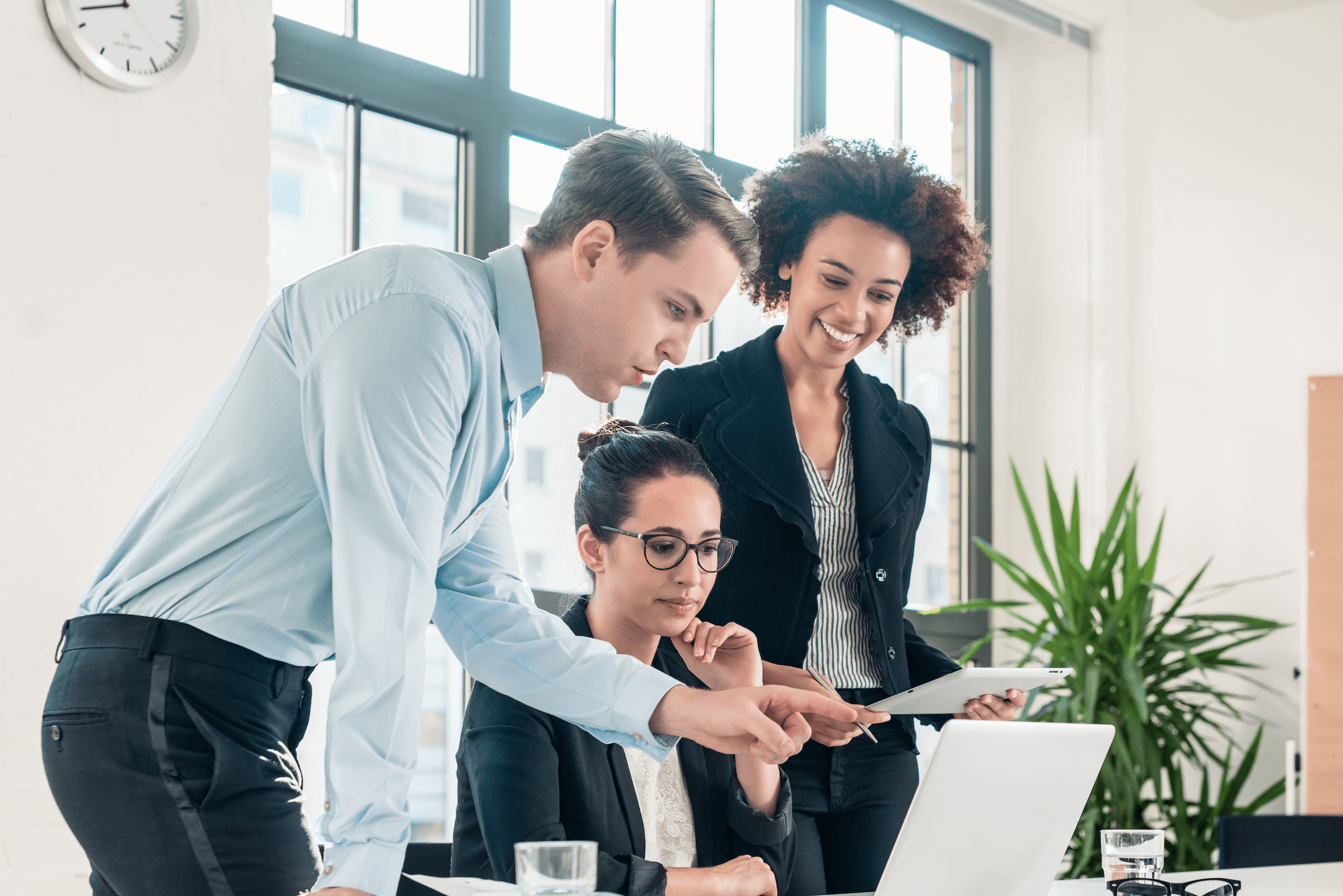 colleagues train coworker at desk