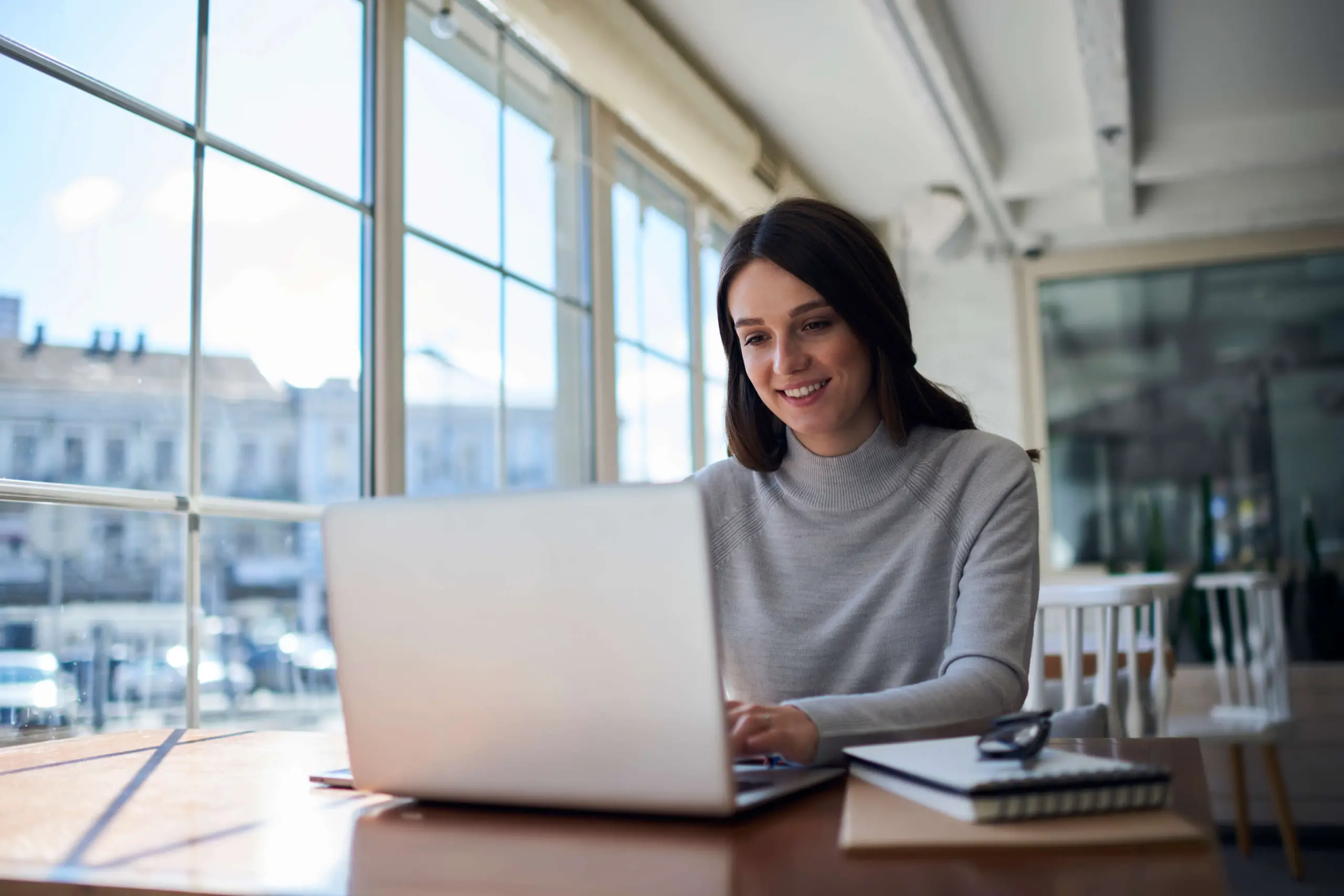 young professional smiling at desk