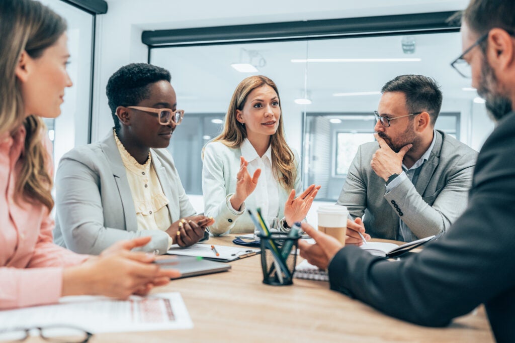 Group of hiring managers talking around a table